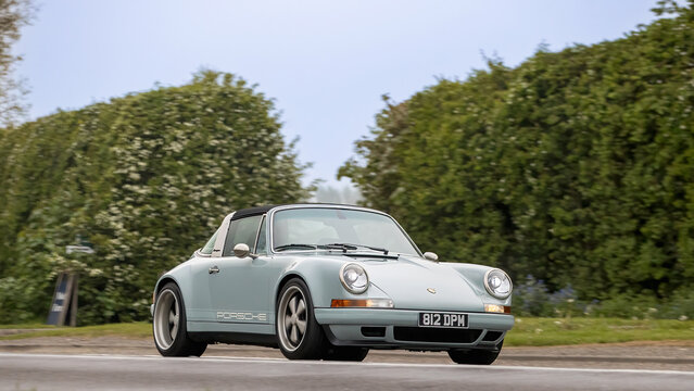 Bicester,Oxon.,UK - Apr 26th 2026: 1993 blue Porsche 911 Carrera 2 Targa car driving on a British road