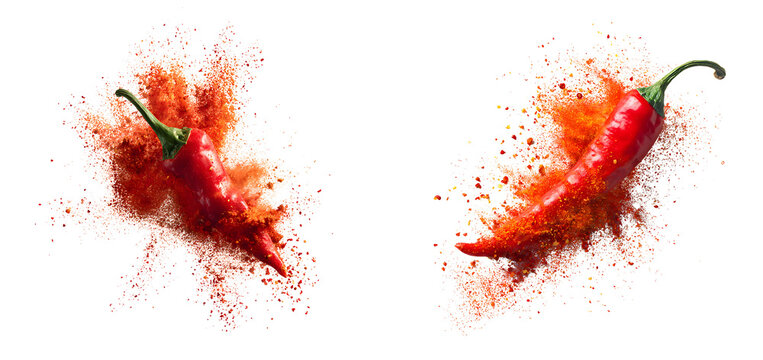 Two vibrant red chili peppers exploding into burst of spicy powder showcasing dynamic motion and bold colors against clean isolated on a white or transparent background