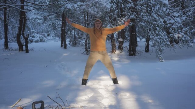 Man performing breathing practice in snowy forest winter, focused outdoor activity improving wellness and endurance in cold conditions