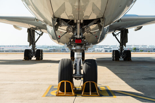 Front view of wide-body aircraft landing gear on tarmac