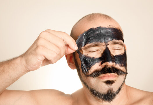 Male facial skincare with charcoal peel-off mask