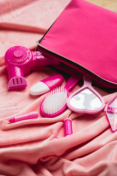 Pink pretend play hairdresser kit on soft fabric background