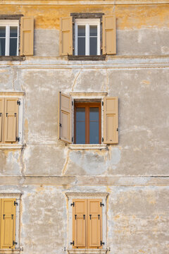 Vintage facade with rustic windows in Borgo Valsugana