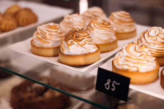 Close up of lemon meringue tart in bakery display case
