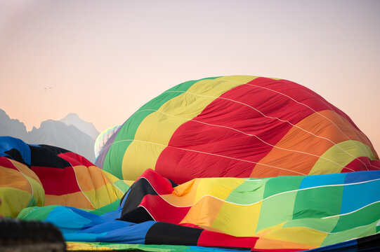 Colorful hot air balloon preparing for early morning flight