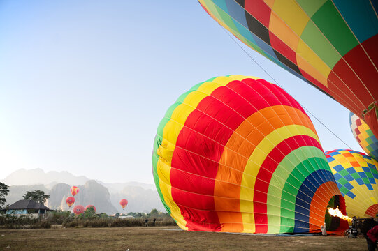 Colorful hot air balloon inflating before flight over Vang Vieng Laos