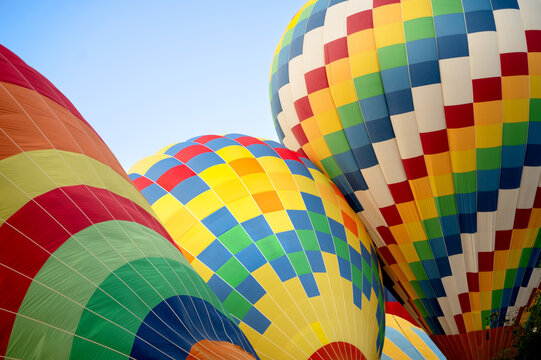 Colorful hot air balloon flight against clear blue sky