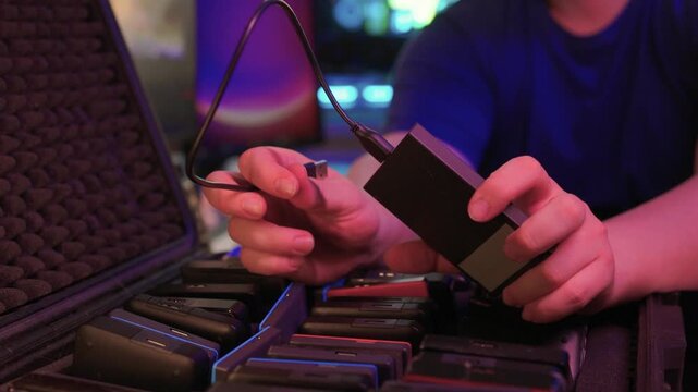Precise sorting of multiple external storage devices in orderly rows. Systematic placement of various external hard discs emphasizing organization and cataloging principles