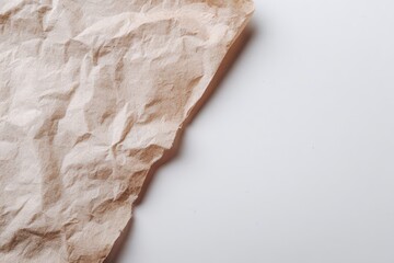 Naklejka premium Crumpled paper texture close-up on pale background with soft shadows