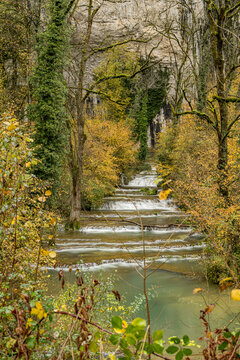 Long exposure waterfall on forest river in Lods, France
