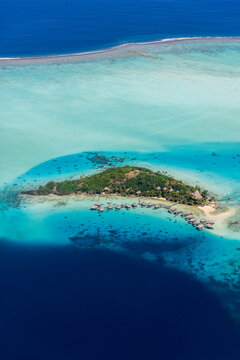 Aerial view of Bora Bora lagoon with reef and islet