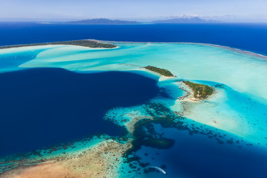 Aerial view of Bora Bora lagoon and coral reef in paradise