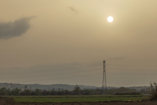Power lines silhouetted against a serene sunset