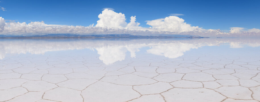 Serene uyuni salt flat in bolivia with water reflection creating surreal landscape