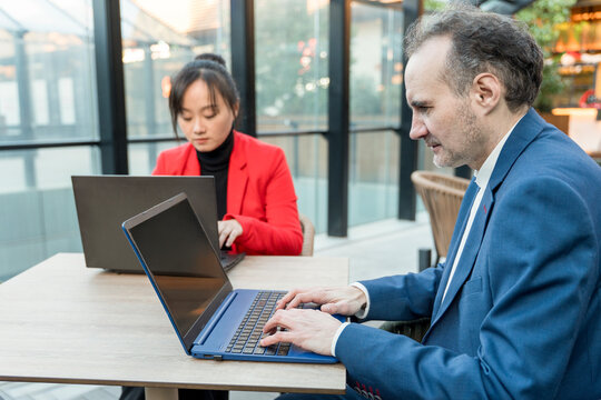 Middle-aged professionals collaborating in modern office