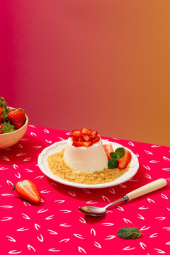 Panna cotta with strawberries on a vibrant background