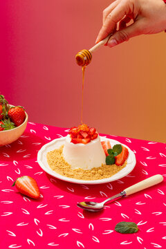 Elegant panna cotta with fresh strawberries and honey