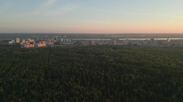 Urban Landscape Blending With Nature. Dusk Reveals City Forms Surrounded By Natural Beauty Contrasts. Clip