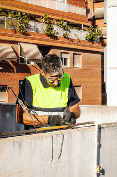 Technician performing rooftop maintenance with safety harness