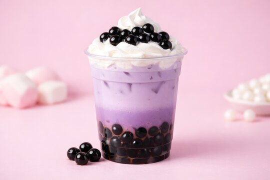 A plastic cup filled with purple taro bubble tea, topped with whipped cream and black tapioca pearls, set against a soft light pink background