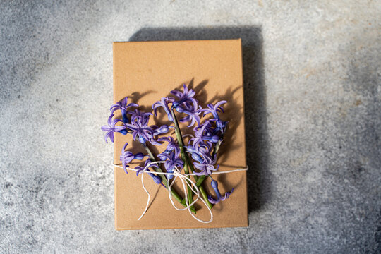 Hyacinth flowers on gift box signaling spring