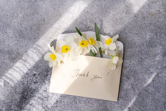 Daffodils in an envelope with thank you card
