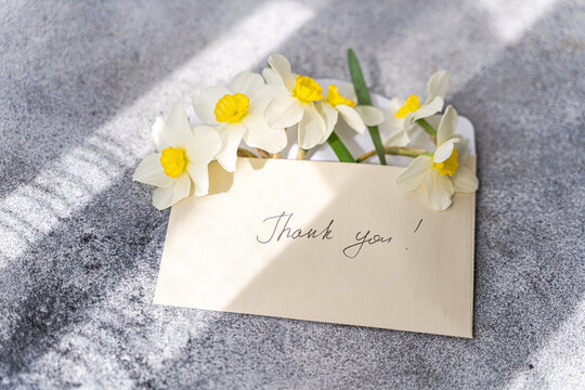 Daffodils in an envelope with handwritten note
