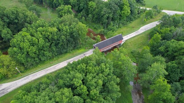 Aerial drone footage of a historic Netcher road covered bridge in the Ohio countryside