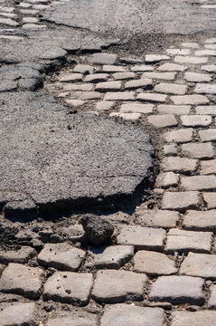 old stone road after damage from frost in winter
