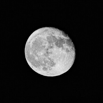 The serene beauty of a full moon in a clear night sky