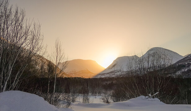 Serene winter sunset over snowy mountains
