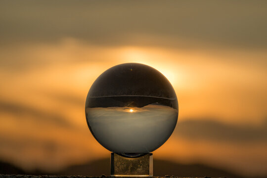 Crystal ball reflecting sunset during golden hour