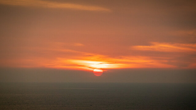 Golden hour sunset over tranquil ocean horizon