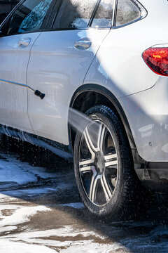 Car wash with high pressure water spray on wheel