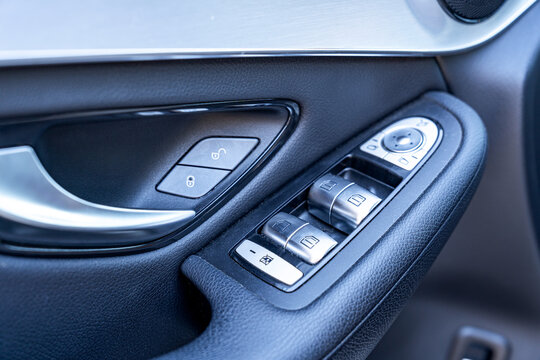 Close-up of car door control panel with window switch