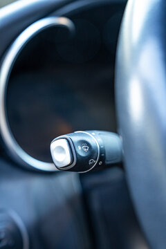 Close-up of car windshield wiper control stalk on dashboard