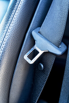 Close-up of car seat belt buckle on leather seat texture