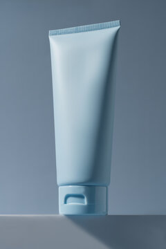 Minimal cosmetic cream tube mockup on blue background