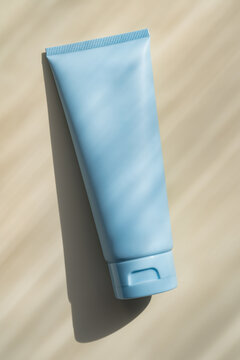 Minimal blue cosmetic cream bottle tube with soft shadow