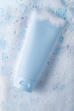 Cosmetic cream tube mockup on bubbly foam background