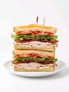 double decker club sandwich with turkey bacon lettuce and tomato on white plate and background