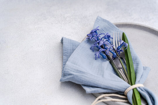 Soft blue hyacinth bouquet on linen in calm interior