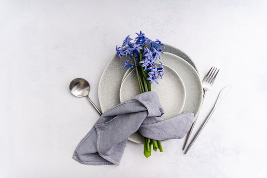 Minimal interior table setting with blue hyacinth bouquet