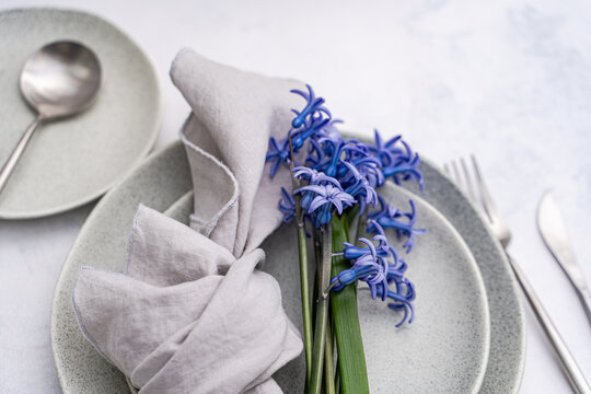 Minimalist table setting with blue hyacinth flowers