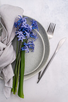 Elegant hyacinth flowers on table setting in modern interior
