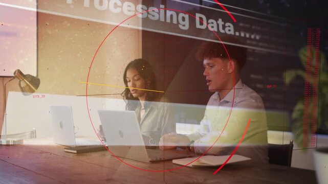 Woman typing, man checking notes at table, opening laptops activating data HUD overlaying frame