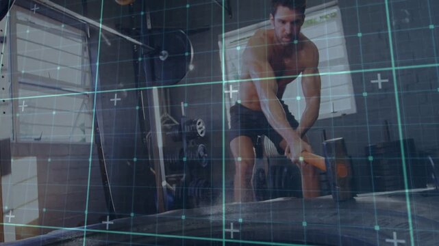 Man raising hammer and striking tire with varying angles and teal grid tracking motion for fitness