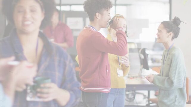 Man raising cup causing animated bubbles while team chatting and checking phone during office break
