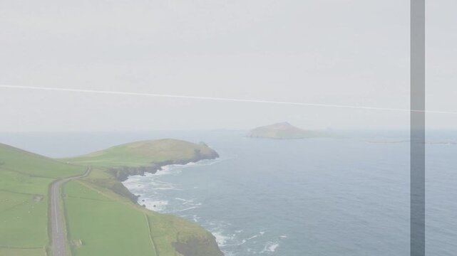 Drone holding view filming coast, framing shifts creating faint bars and contrail across sky