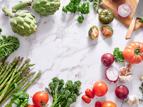 Fresh vegetables on marble countertop for healthy cooking